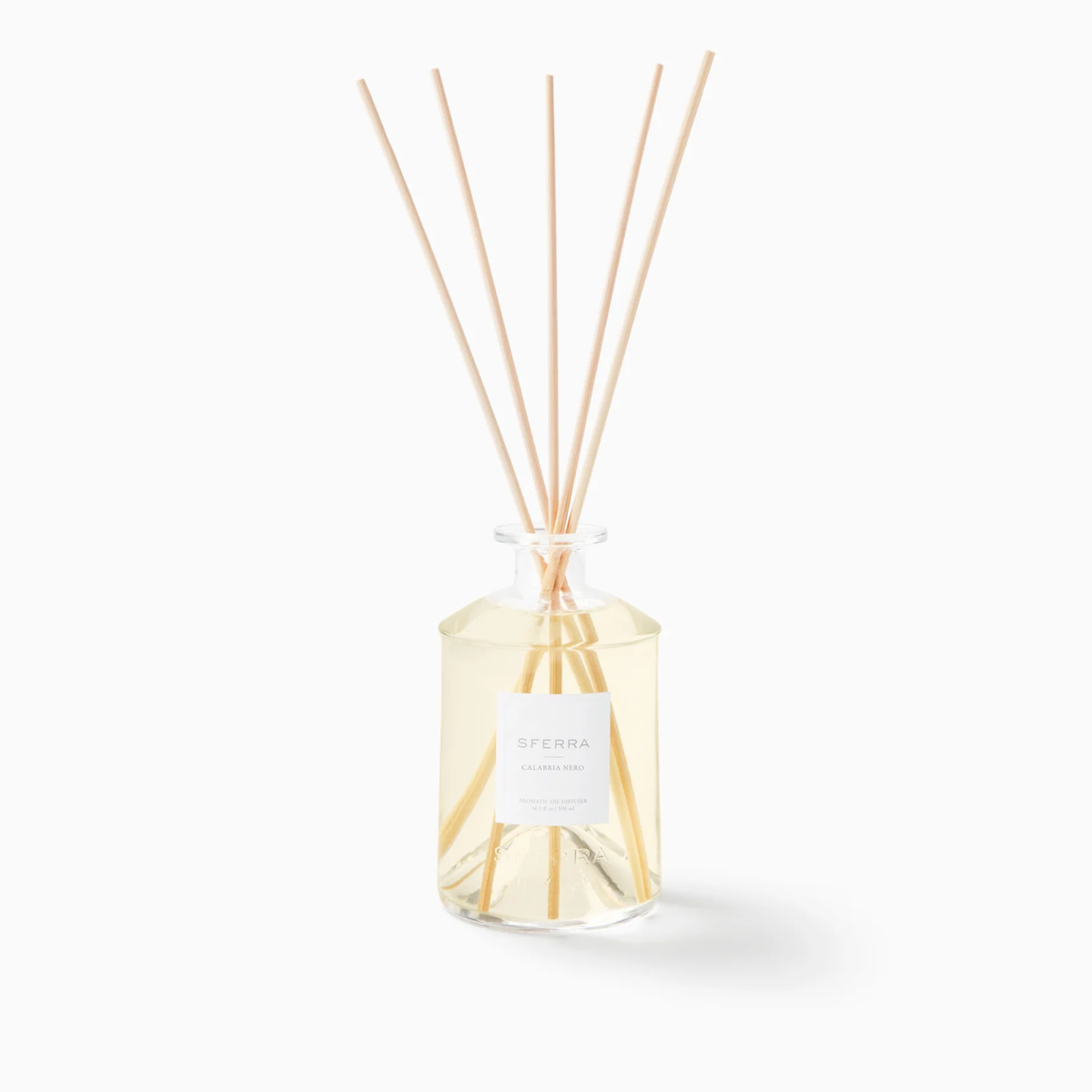 Clear glass reed diffuser with Calabria Nero scent and reeds, inspired by Sferra Profumo di Casa luxury home scents.
