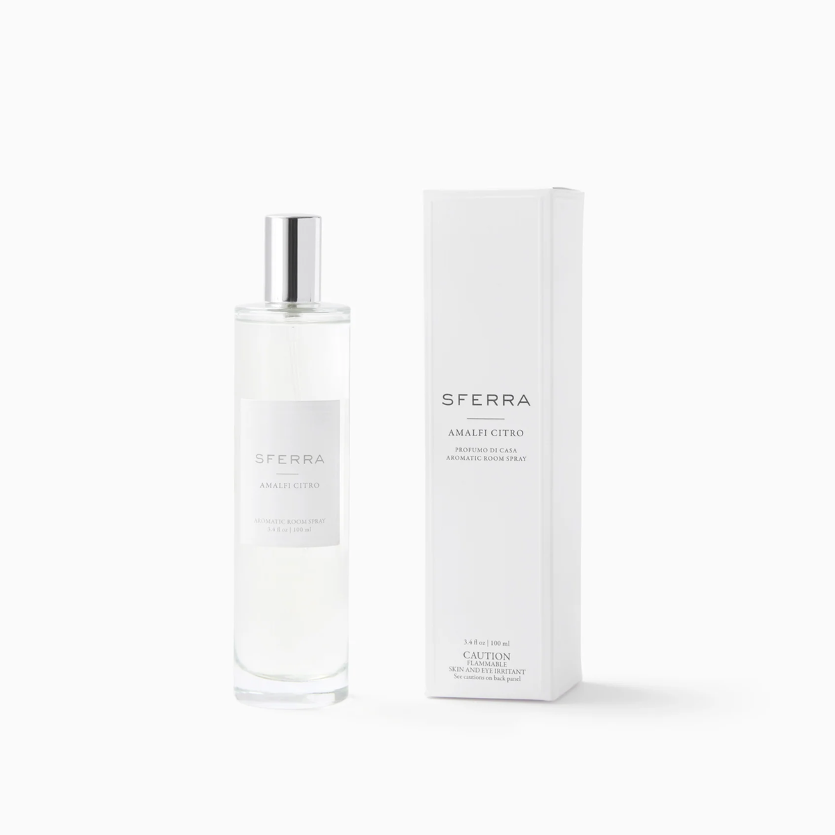 A clear bottle of SFERRA home fragrance in Amalfi citrus scent stands beside its white, rectangular box.