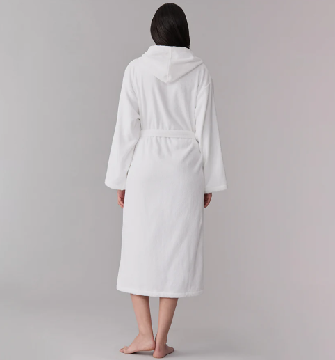A person in a Sferra Bello Nuovo Robe stands barefoot, facing away against a plain gray background.