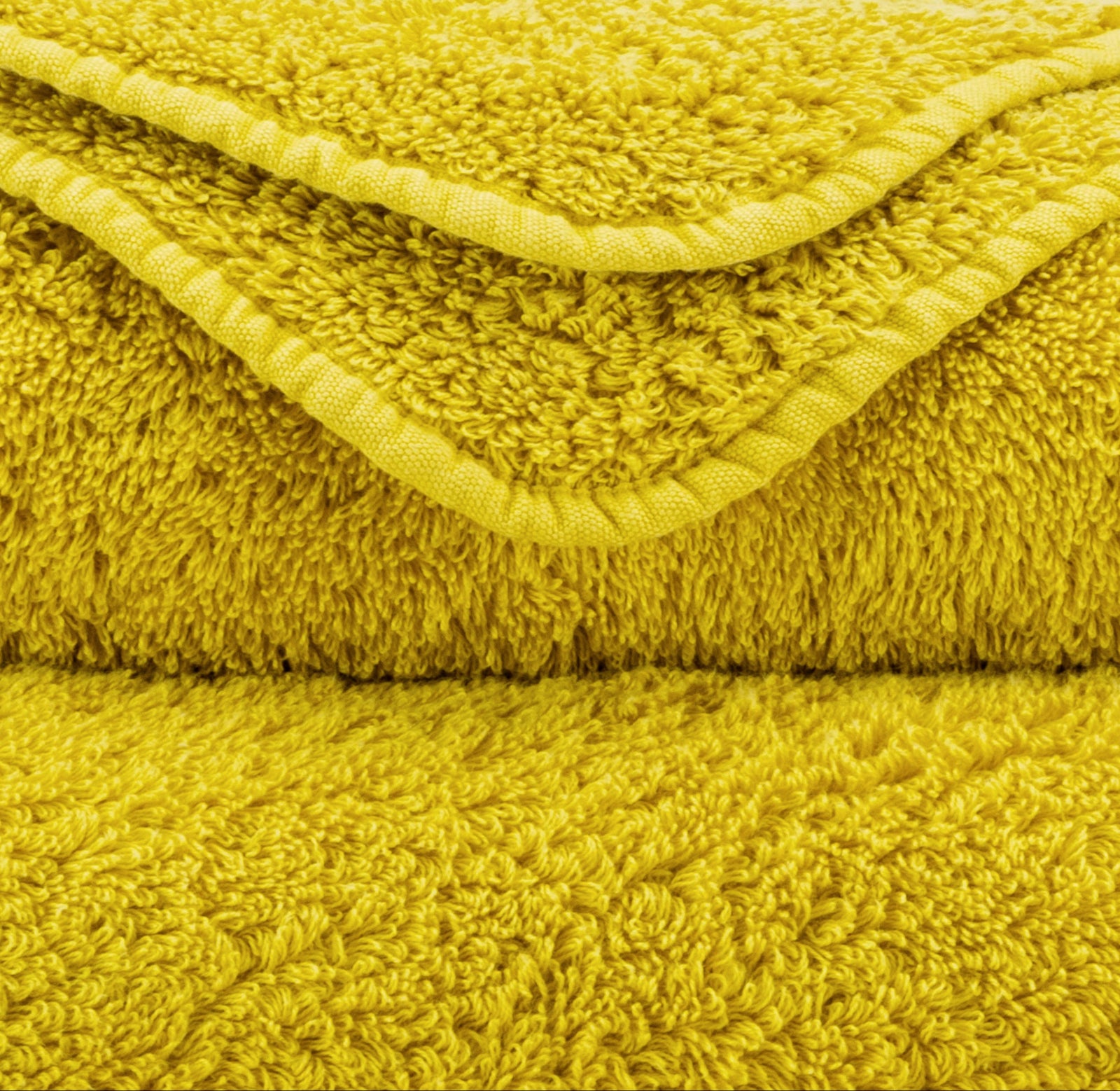 Stack of Abyss Super Pile Bath Towels in Yuzu Color
