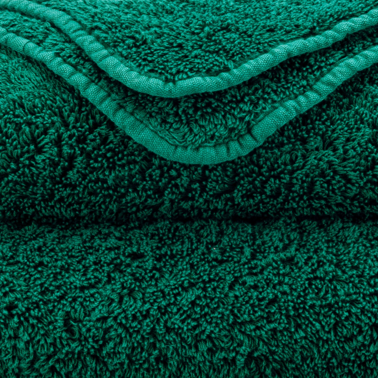 Stack of Abyss Super Pile Bath Towels in British Green Color