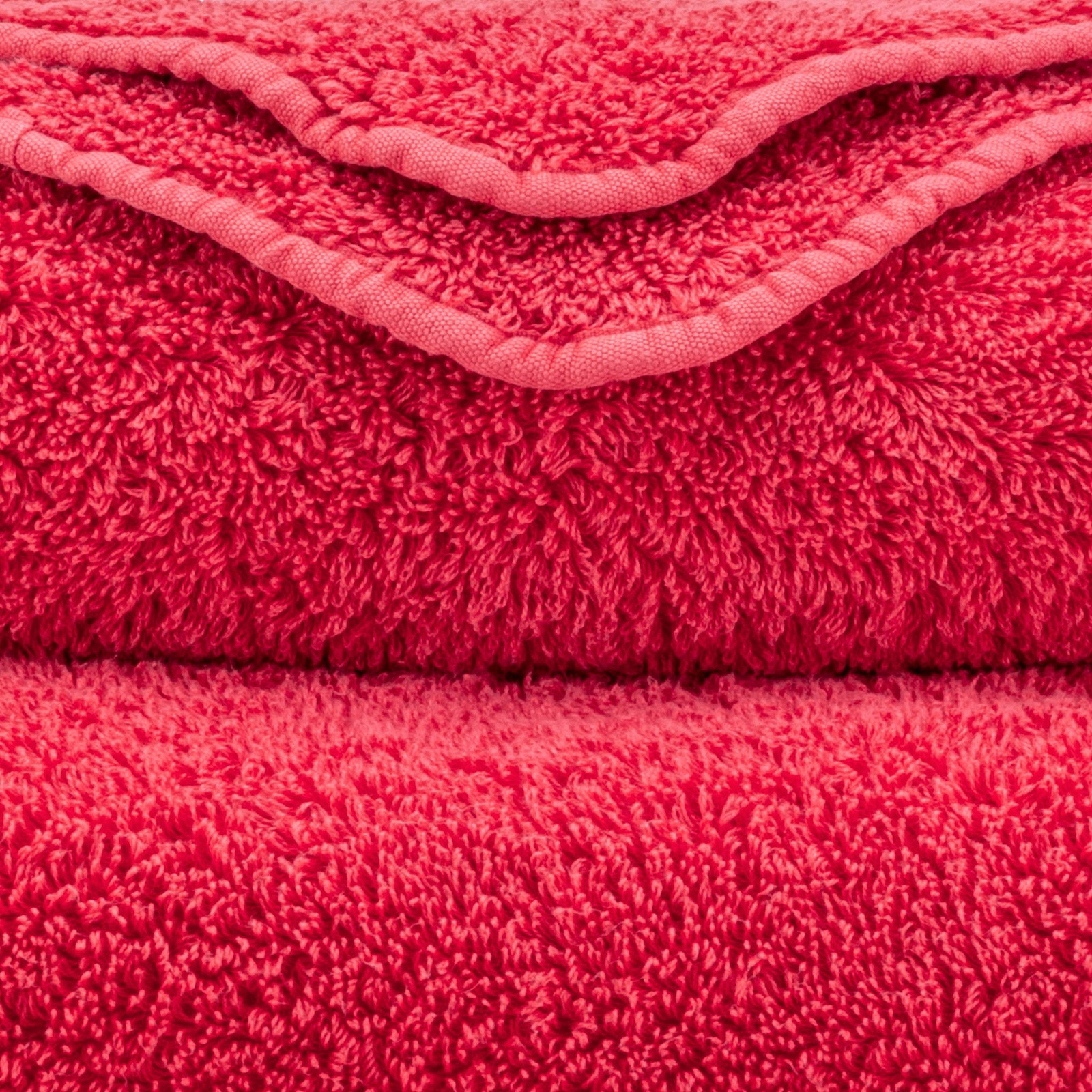 Stack of Abyss Super Pile Bath Towels in Viva Magenta Color