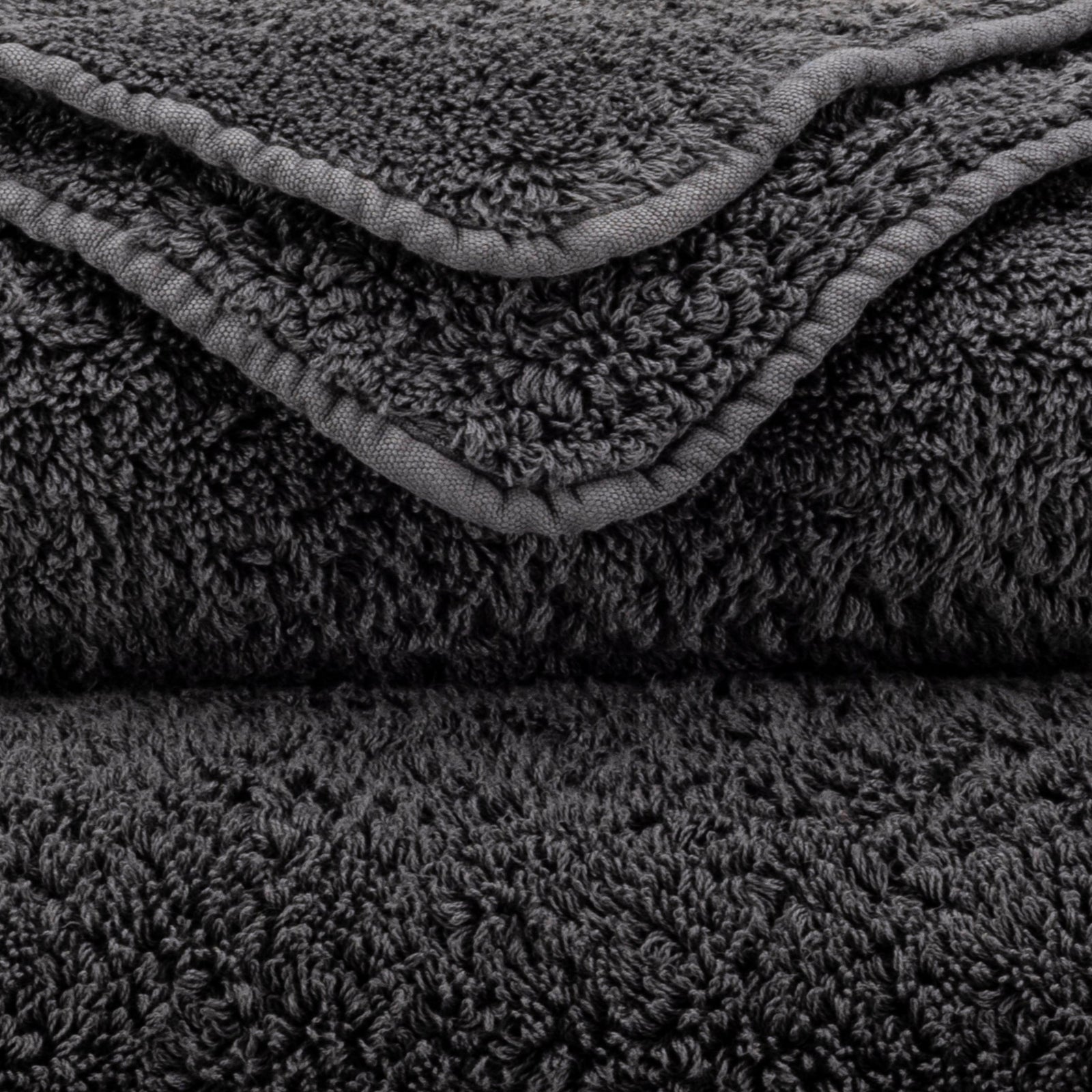Stack of Abyss Super Pile Bath Towels in Volcan Color