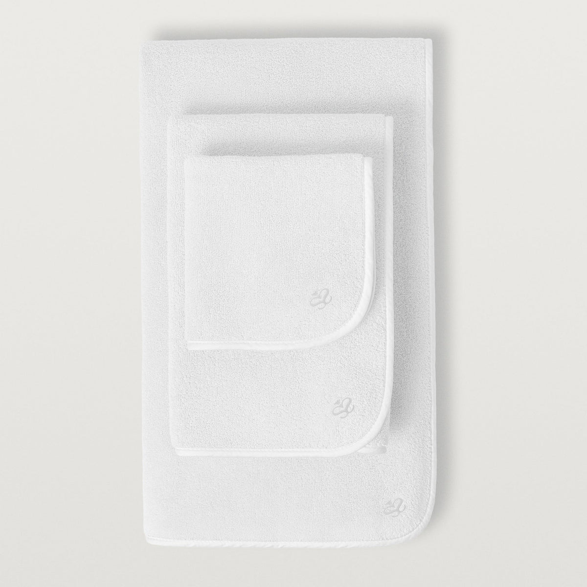 Three neatly stacked Scandia Home Delfine Bath Towels in White color—luxurious long-staple cotton towels