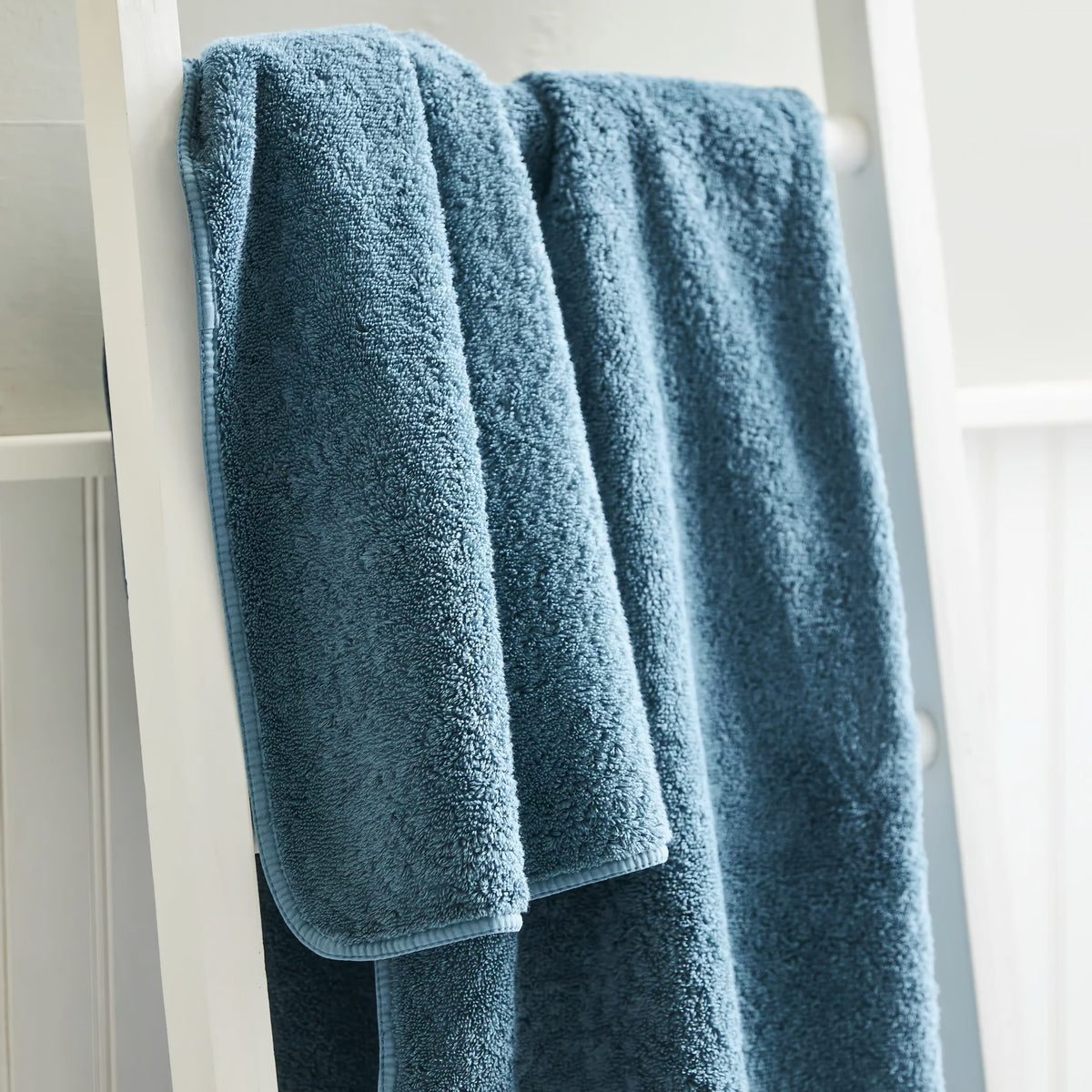 Closeup of Petrol Scandia Home Indulgence Towel in a bathroom