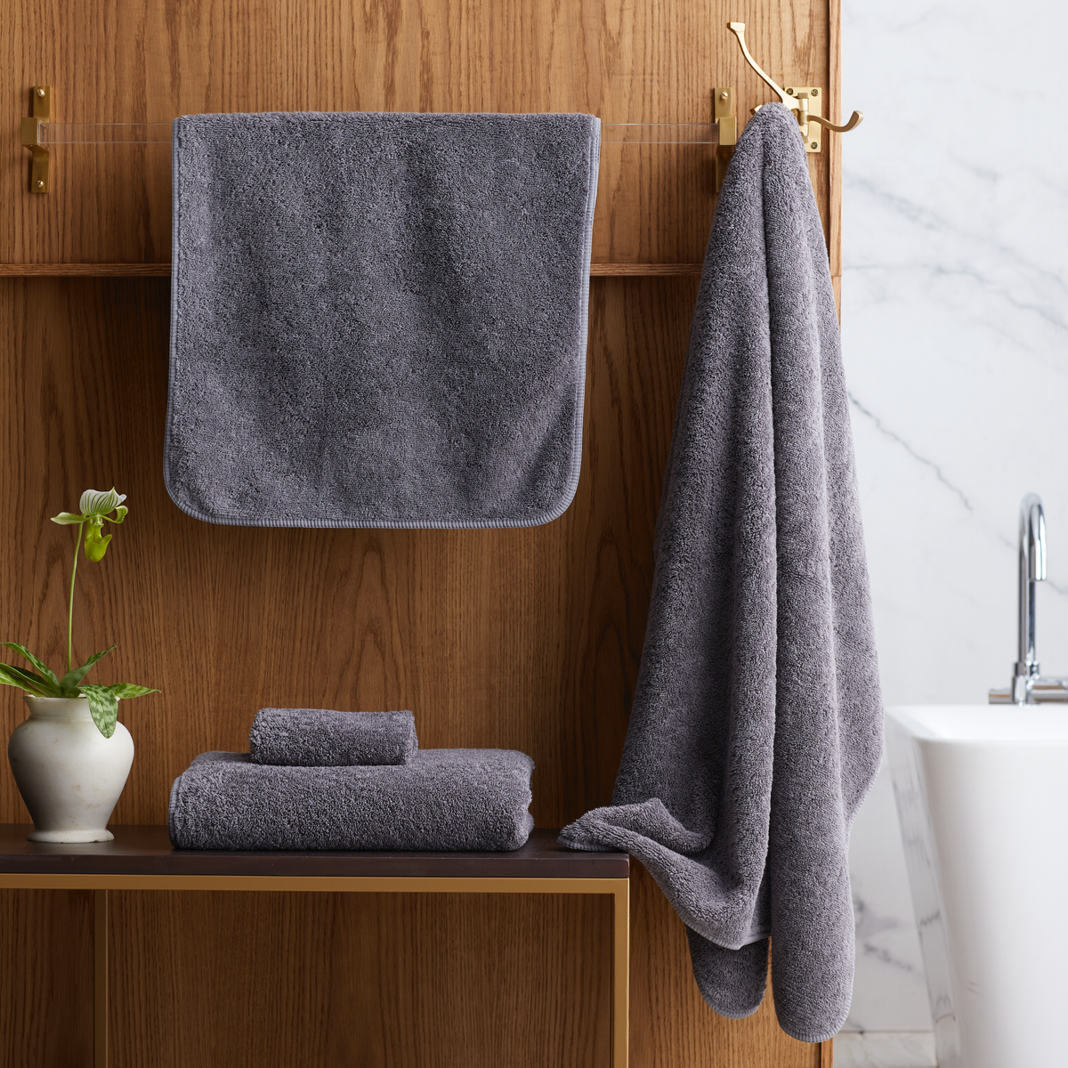 Bathroom with folded Charcoal Scandia Home Indulgence Towels on a shelf and hanging on a towel rack