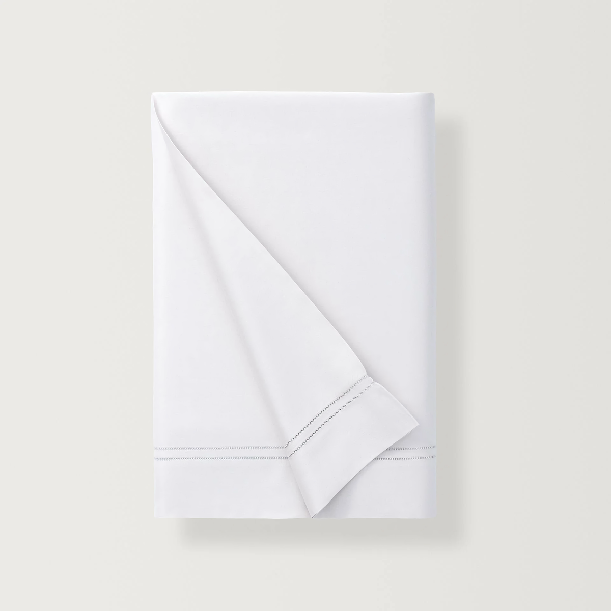 Folded Flat Sheet of White Scandia Home Lucea Sea Island Collection