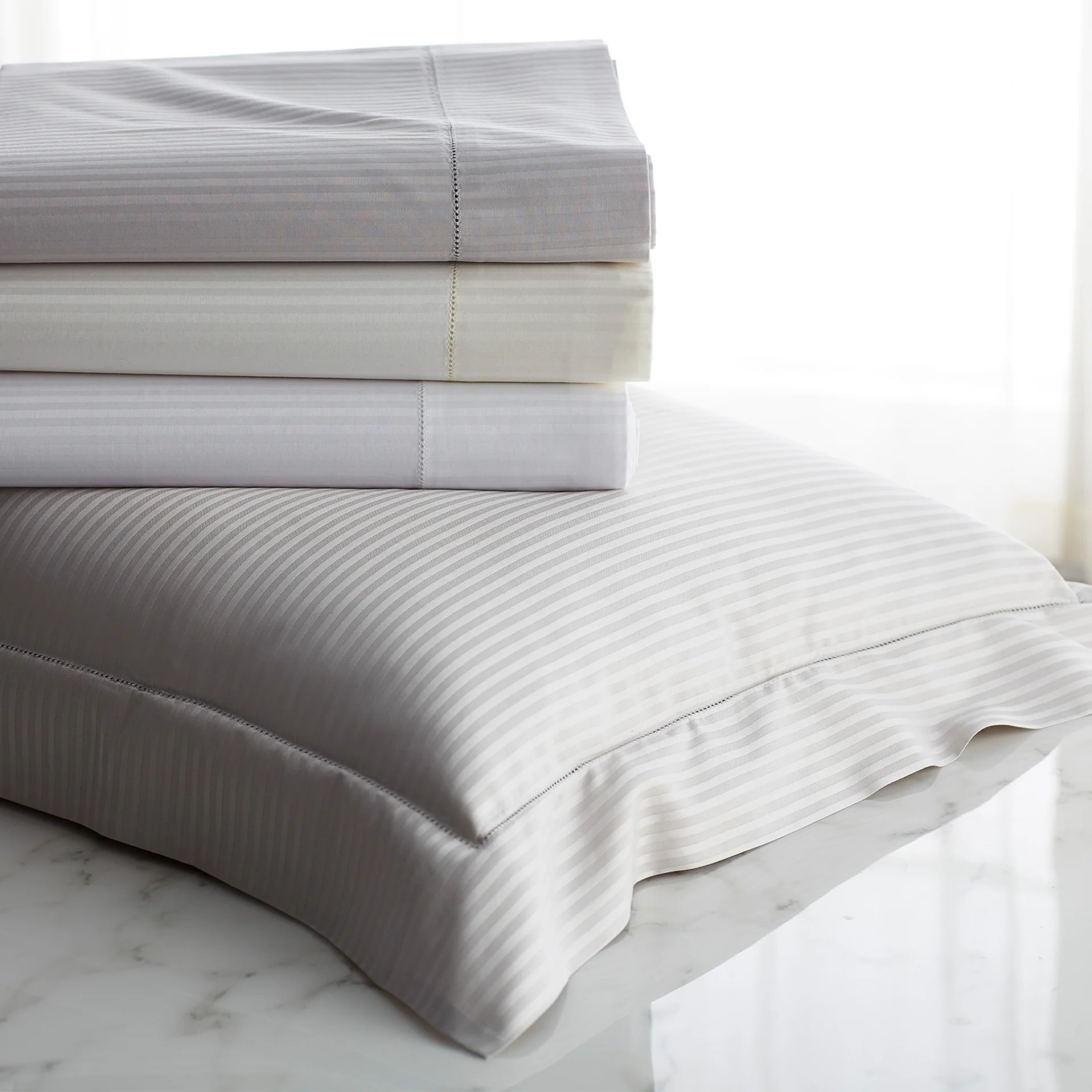 Stack of Folded Scandia Home Savoia Bedding in all colors