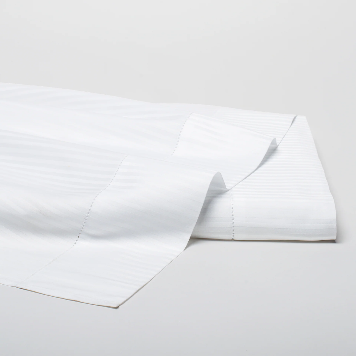 Folded Flat Sheet of White Scandia Home Savoia Bedding Collection