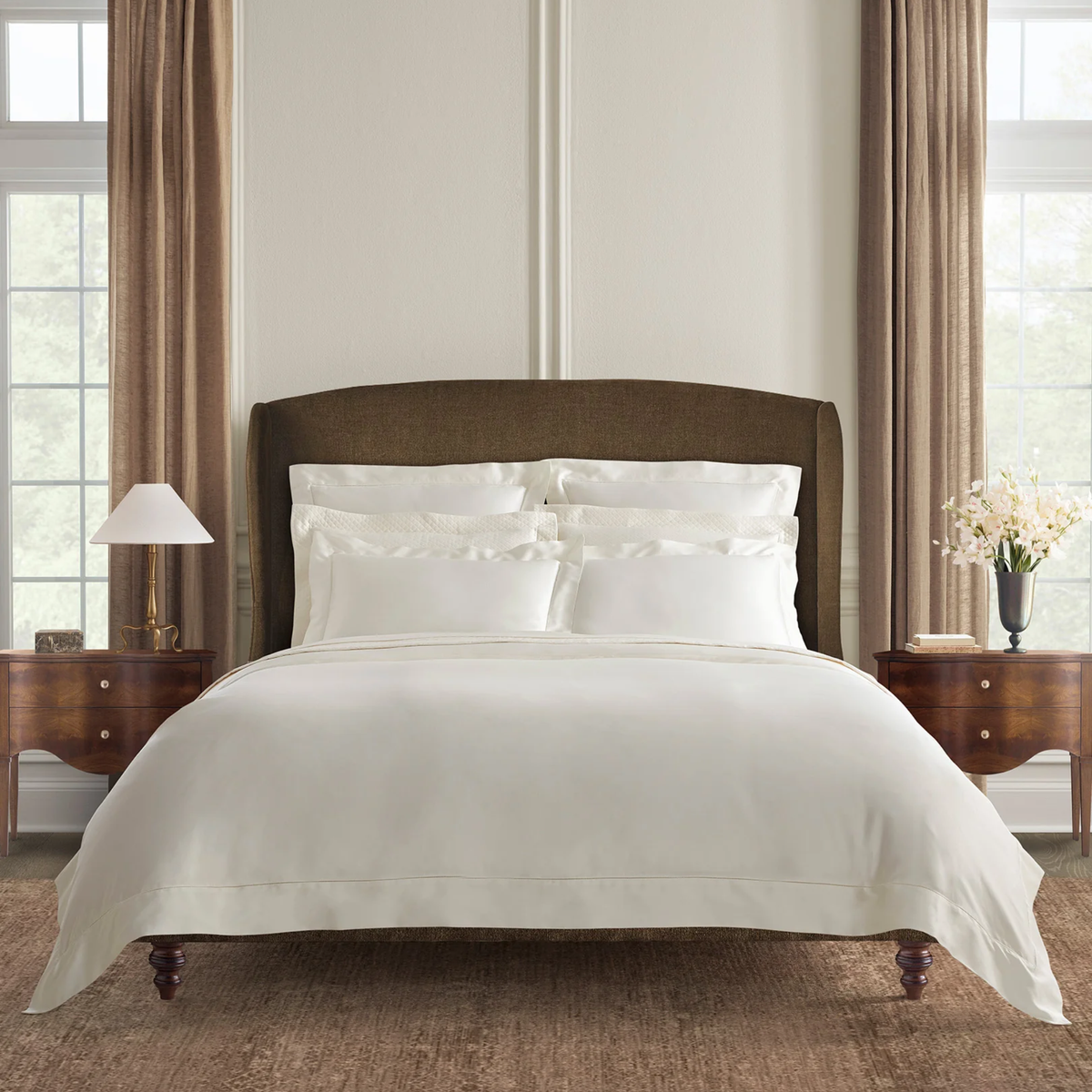 Neatly made bed with Sferra Ariel Bedding in Oyster