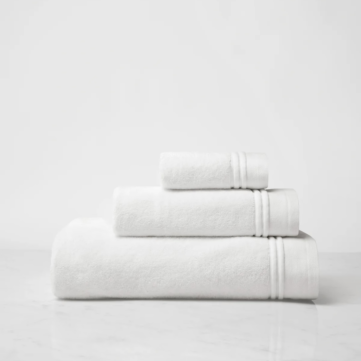 Stack of Sferra Aura Nuova Bath Towels in White and White