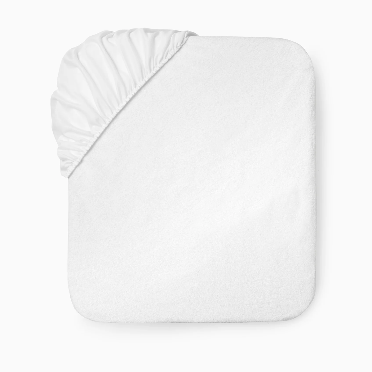 White cotton terry fitted Sferra Bailey Mattress Protector partially covering a rectangular mattress, shown from above on white background.