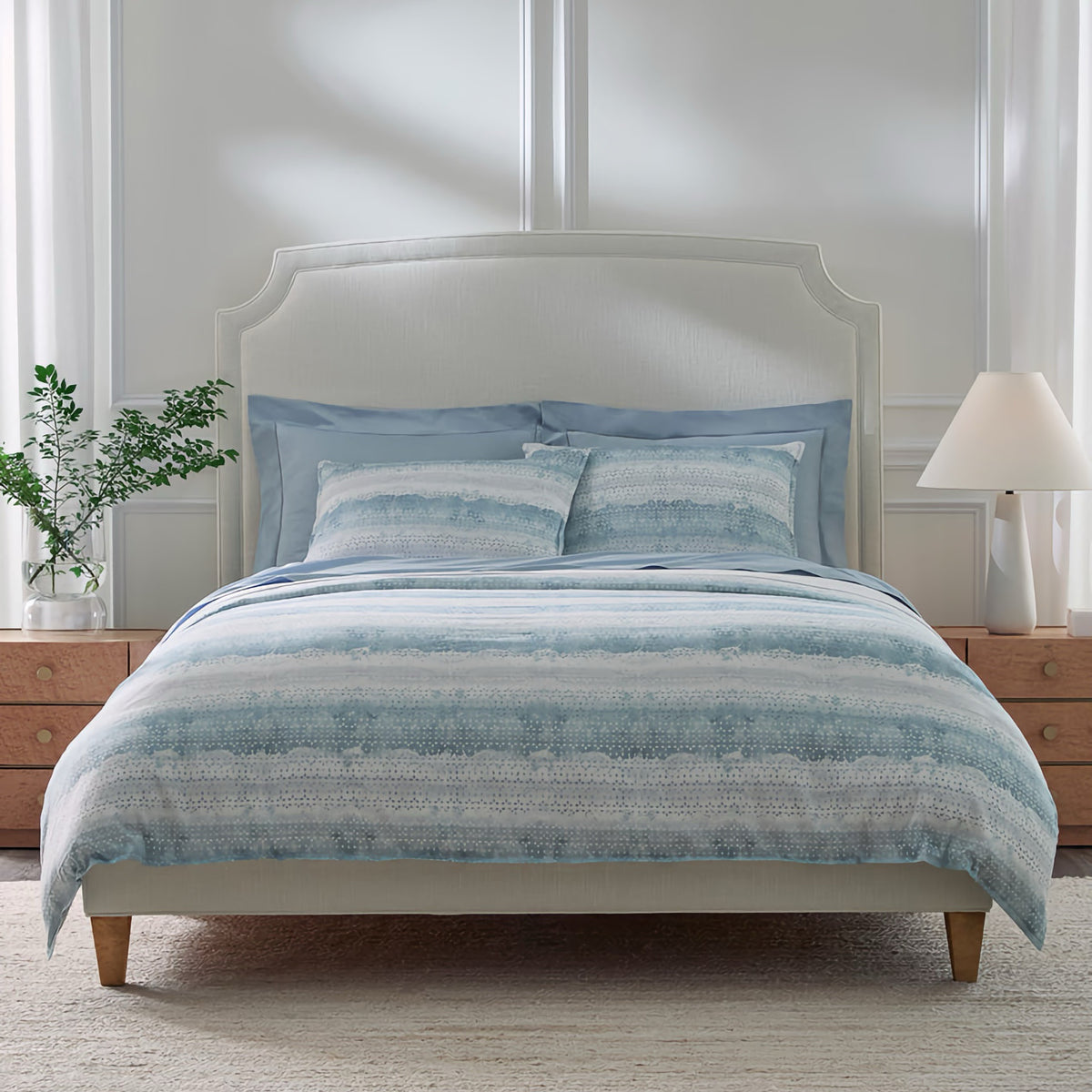 Bed with Sferra Brillanti Duvet Cover and Shams in Sky color