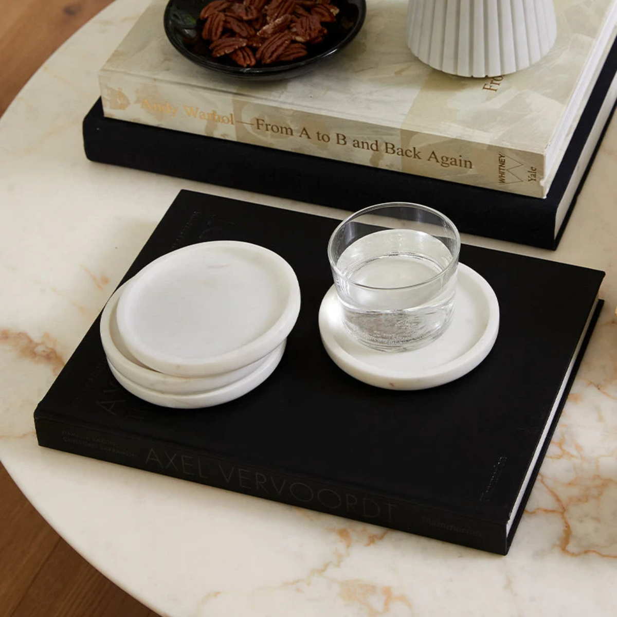 White Sferra Calanna Coasters on a book