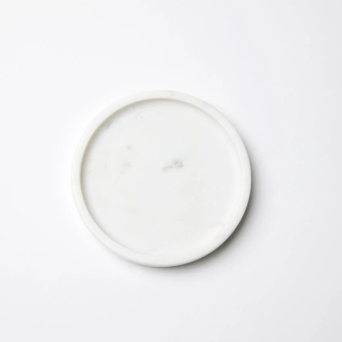 A White Sferra Calanna Coaster against a white background