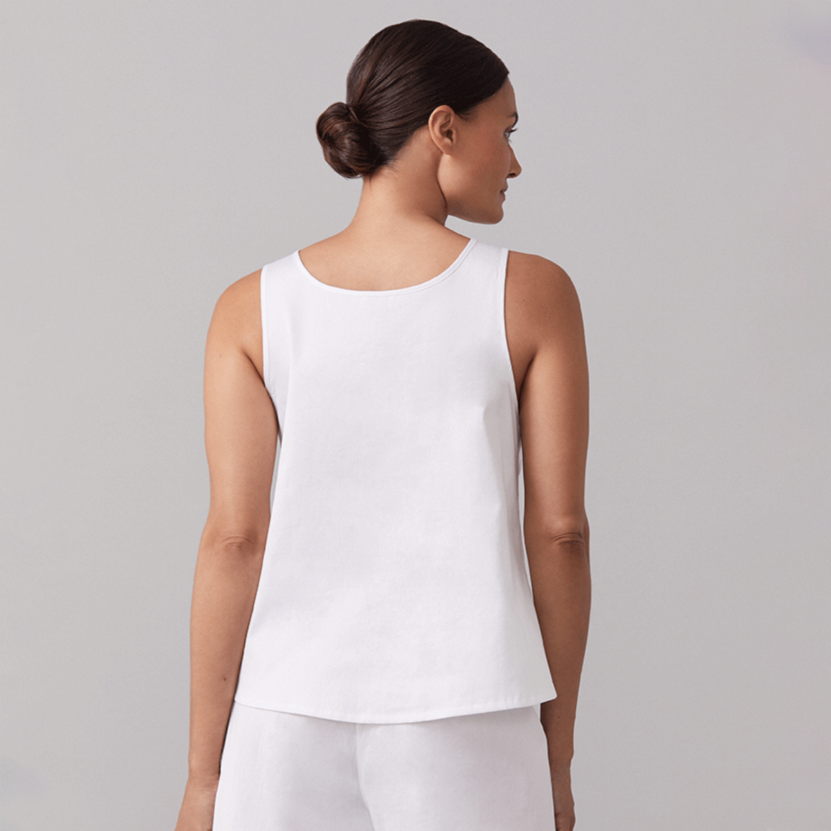Backview of Female Model Wearing a White Sferra Caricia Buttoned Tank Top