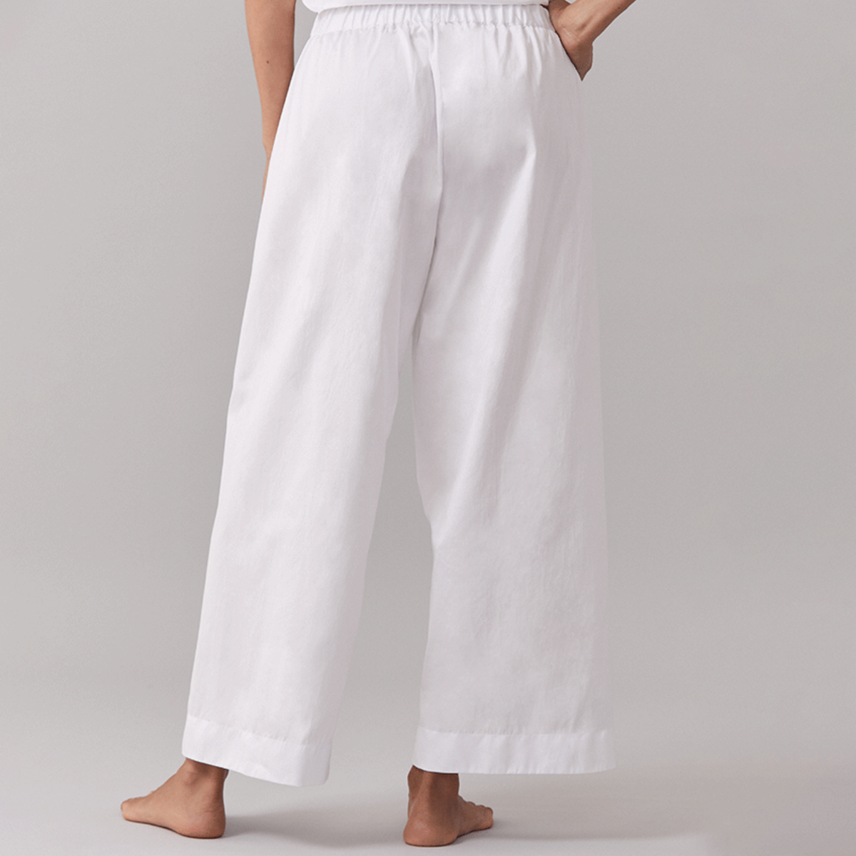 Behind View of White Sferra Caricia Pant Worn by a Woman Model