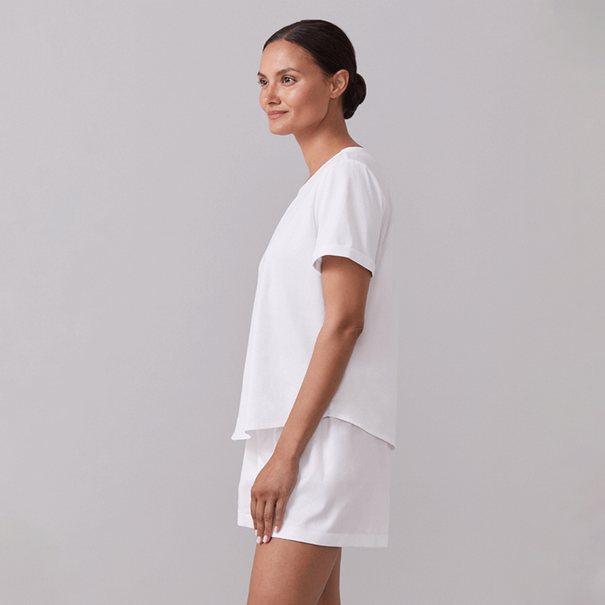 Model Wearing a White Sferra Caricia Short Sleeve Top