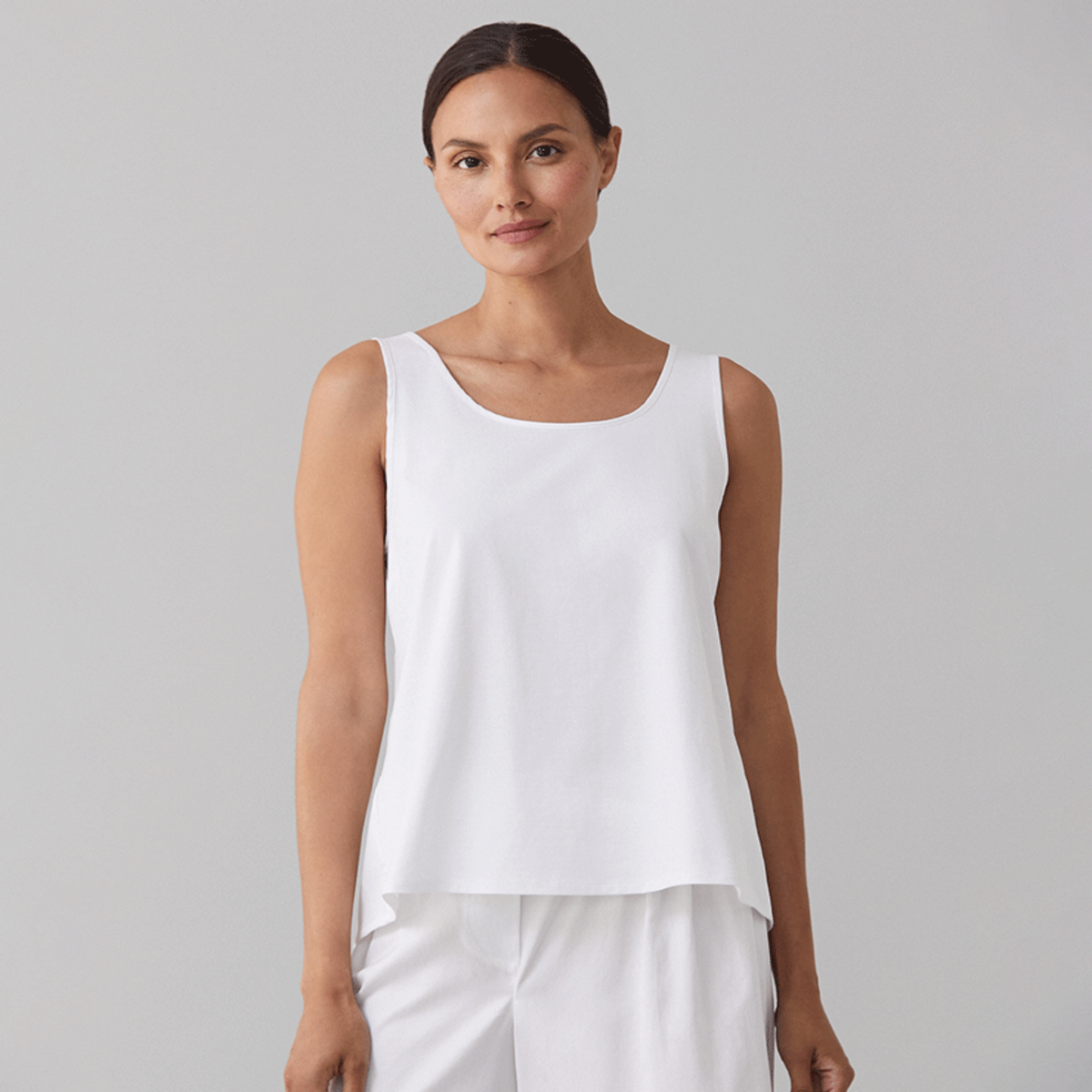 Model Wearing a White Sferra Caricia Swing Tank Top