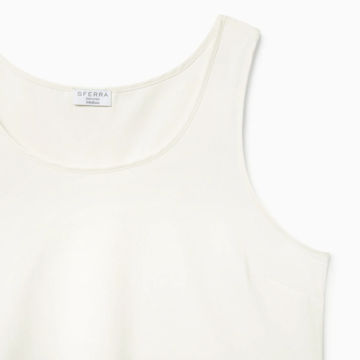 Corner View of Ivory Sferra Caricia Swing Tank Top against a white background