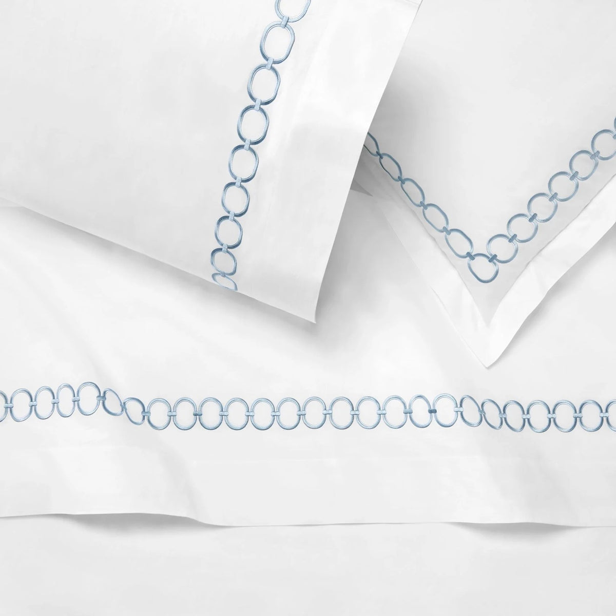 Close Up Shot of Folded Duvet Cover of Sferra Catena Bedding in Color White/Sea