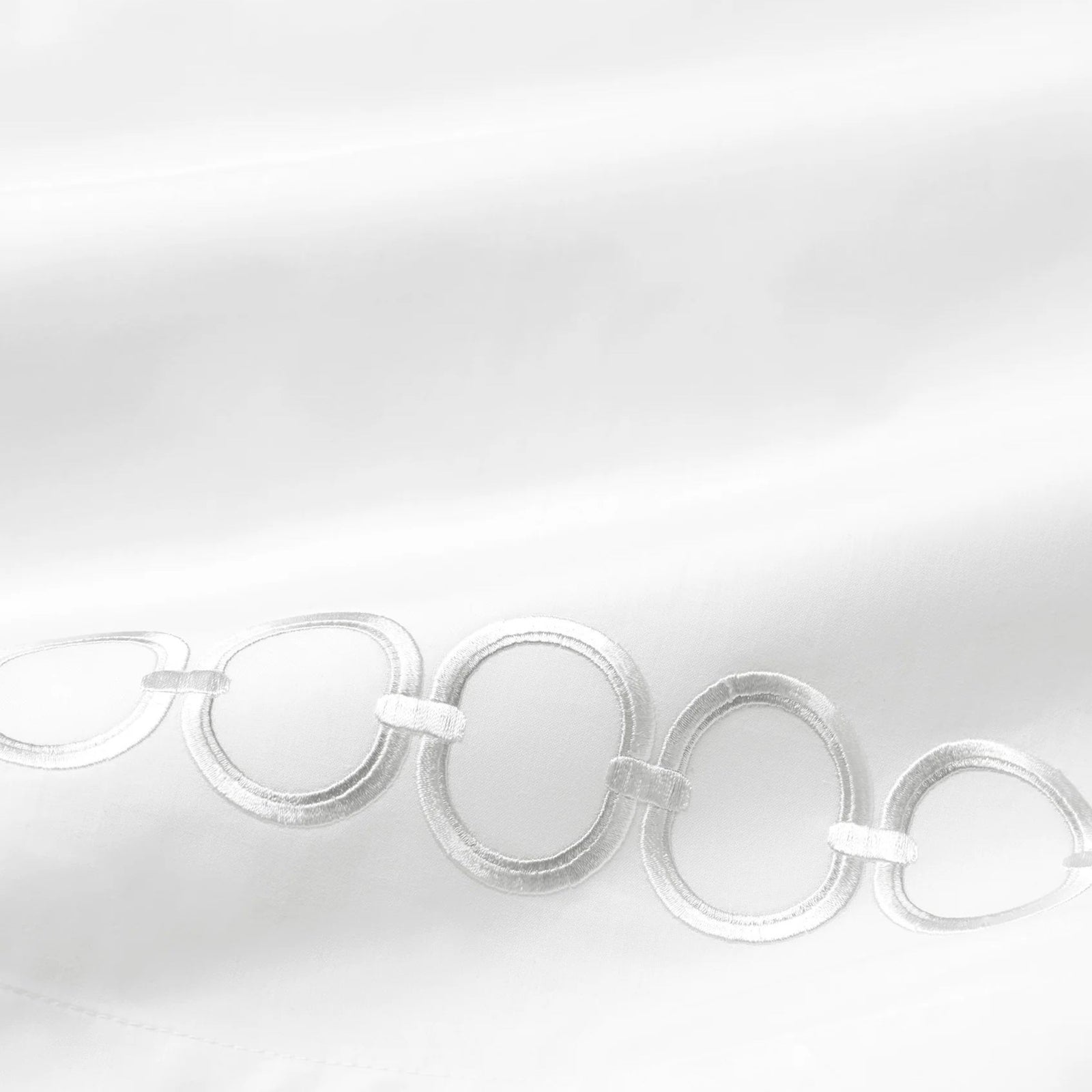 Bed Dressed in Sferra Catena Bedding with Swatch in White/Lunar Color