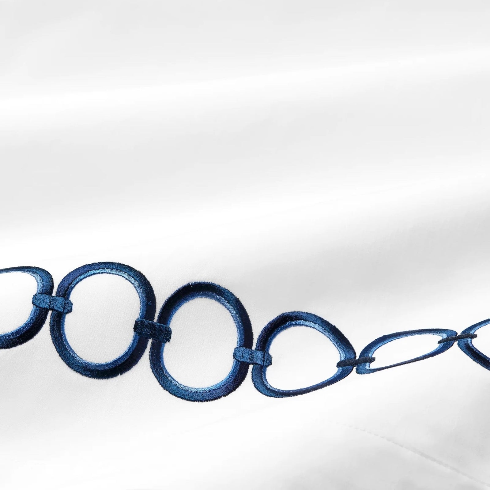 Bed Dressed in Sferra Catena Bedding with Swatch in White/Navy Color