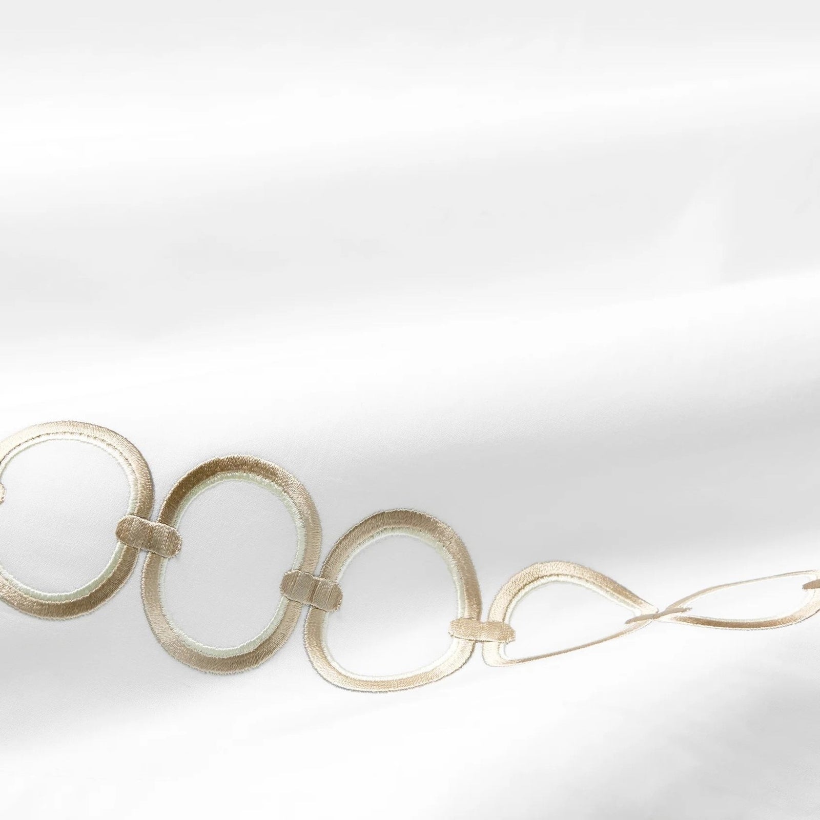 Bed Dressed in Sferra Catena Bedding with Swatch in White/Sand Color