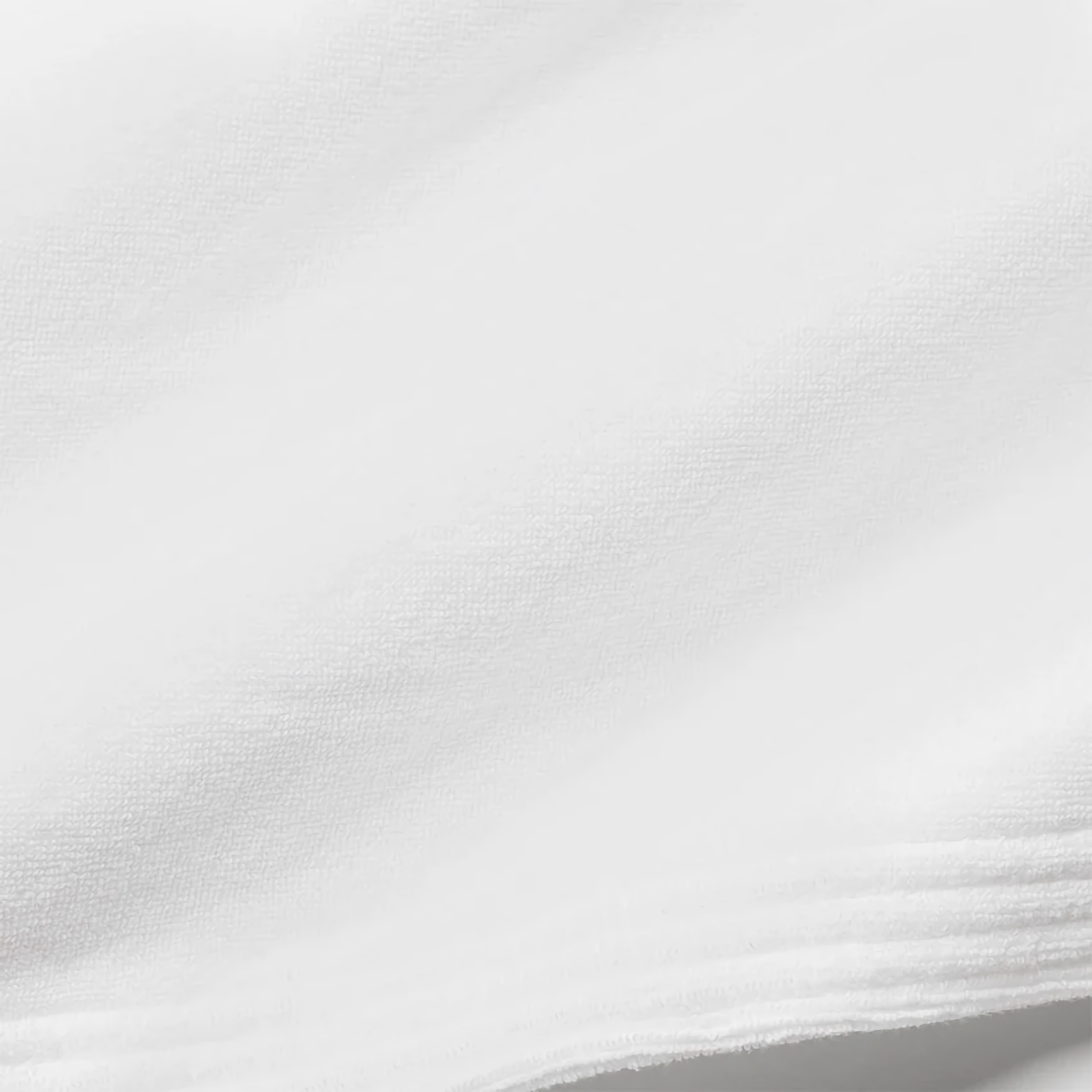 Set of White Sferra Cielo Bath Towels in a White Bathroom