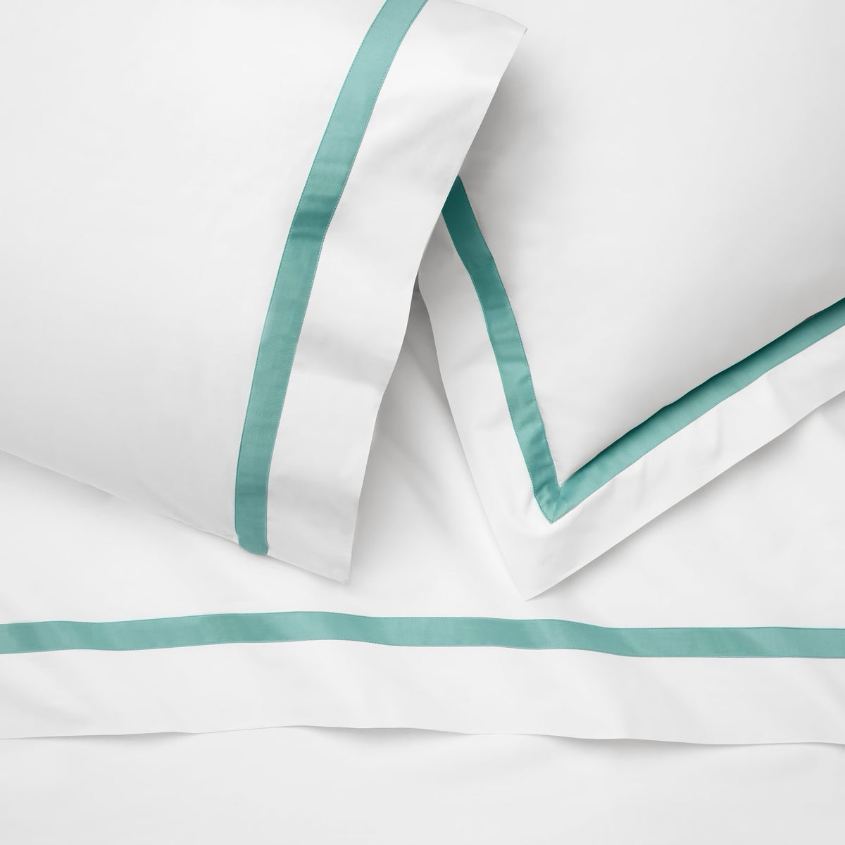Detailed view of Sferra Estate Bedding in White and Aqua color