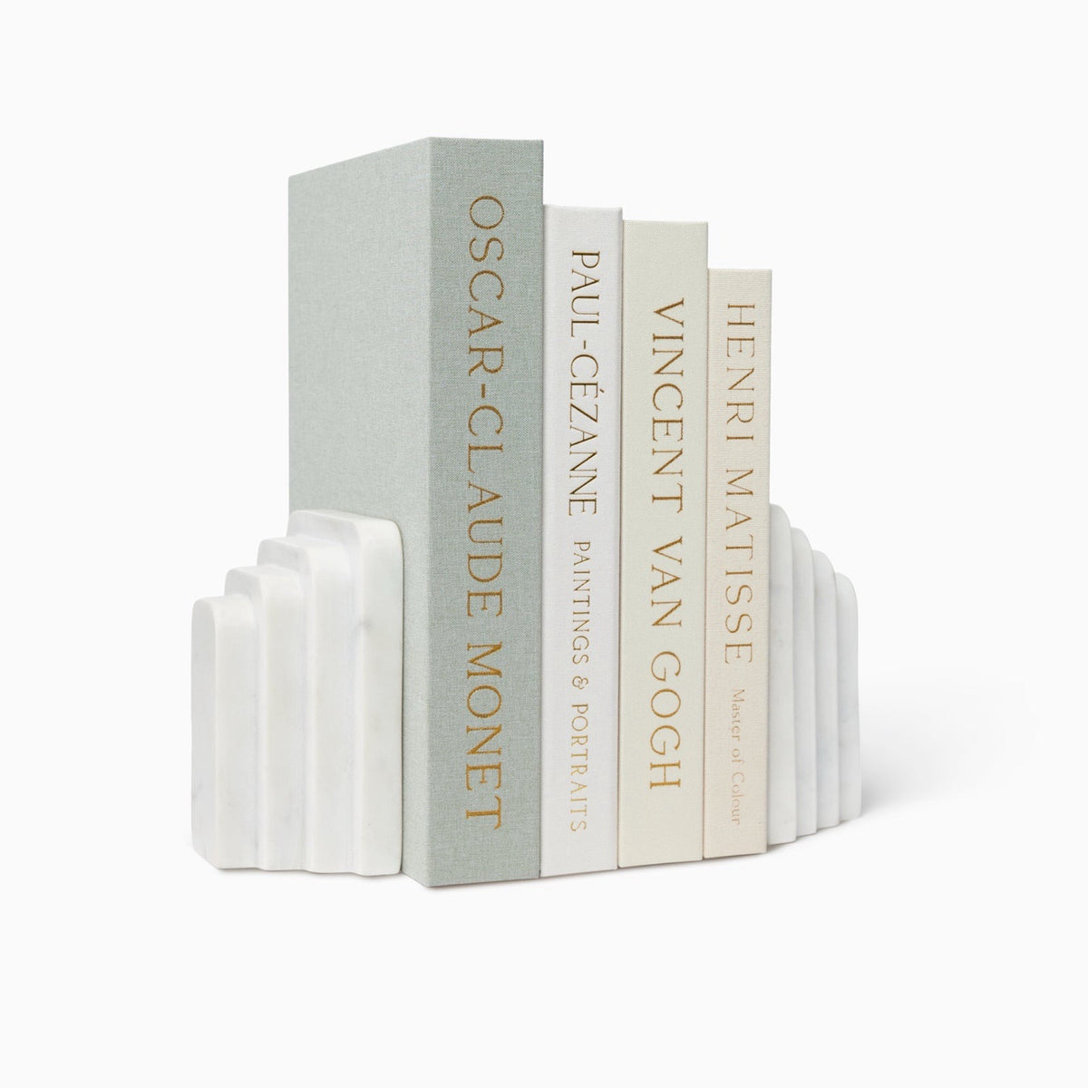 Angled View of Sferra Fermalibri Marble Bookends in white with books