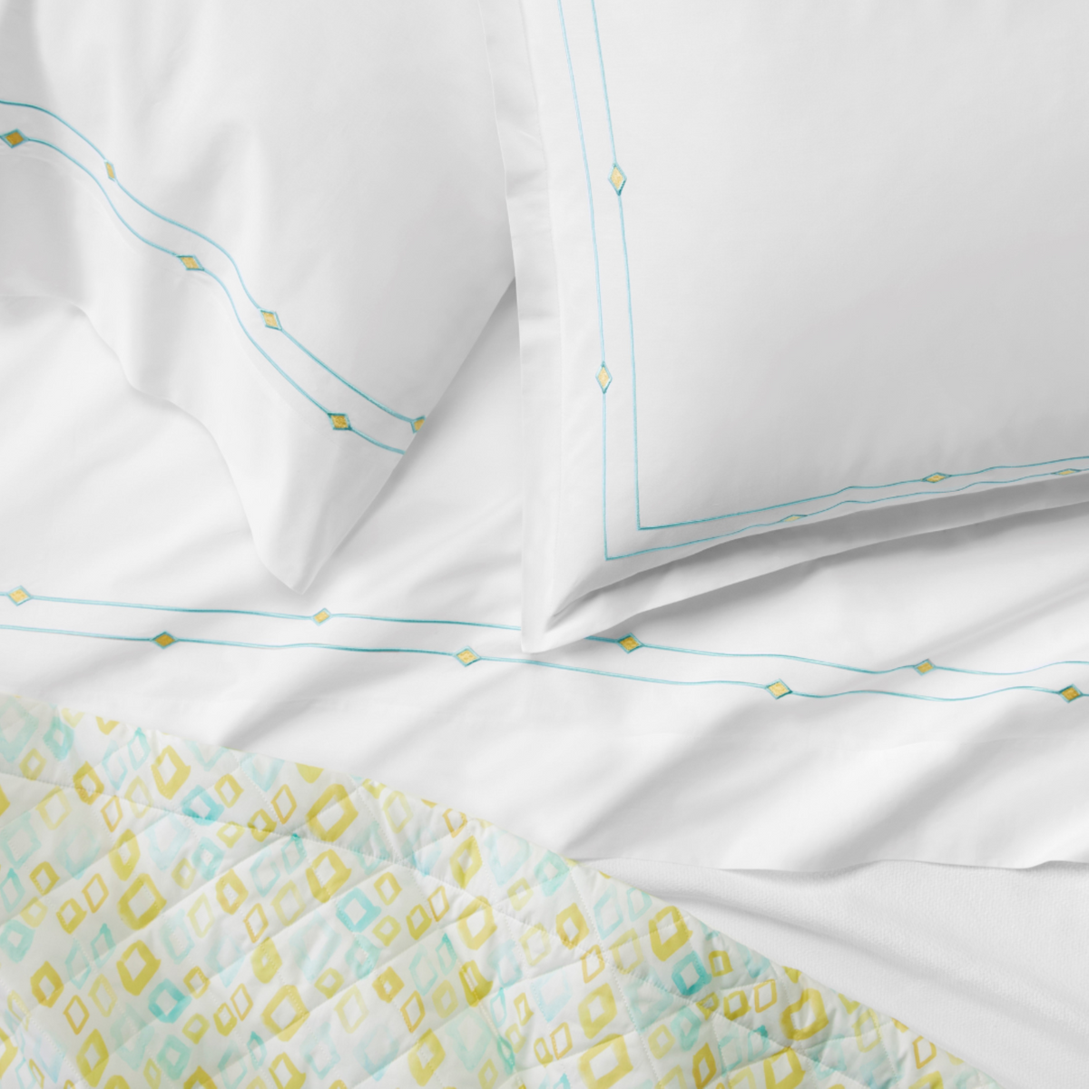 Sferra Geometrico Bedding Lifestyle with Diamanti Pillow Sham and Sheet Aqua