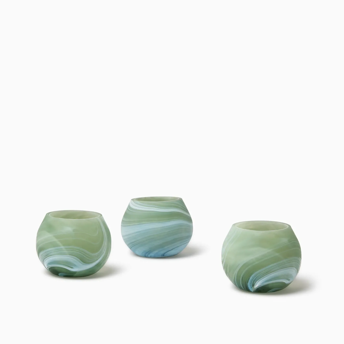 Three round, Clover Sferra Giove Marbled Votive Holders, perfect as bespoke glass accessories for your decor