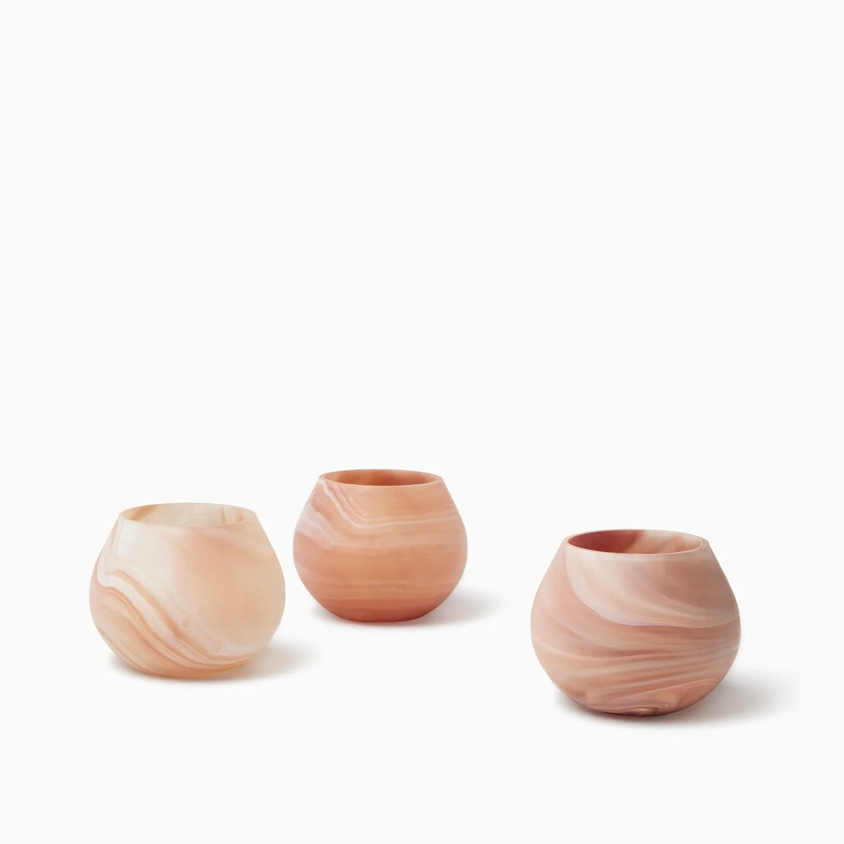 Three round, Paprika Sferra Giove Marbled Votive Holders, perfect as bespoke glass accessories for your decor