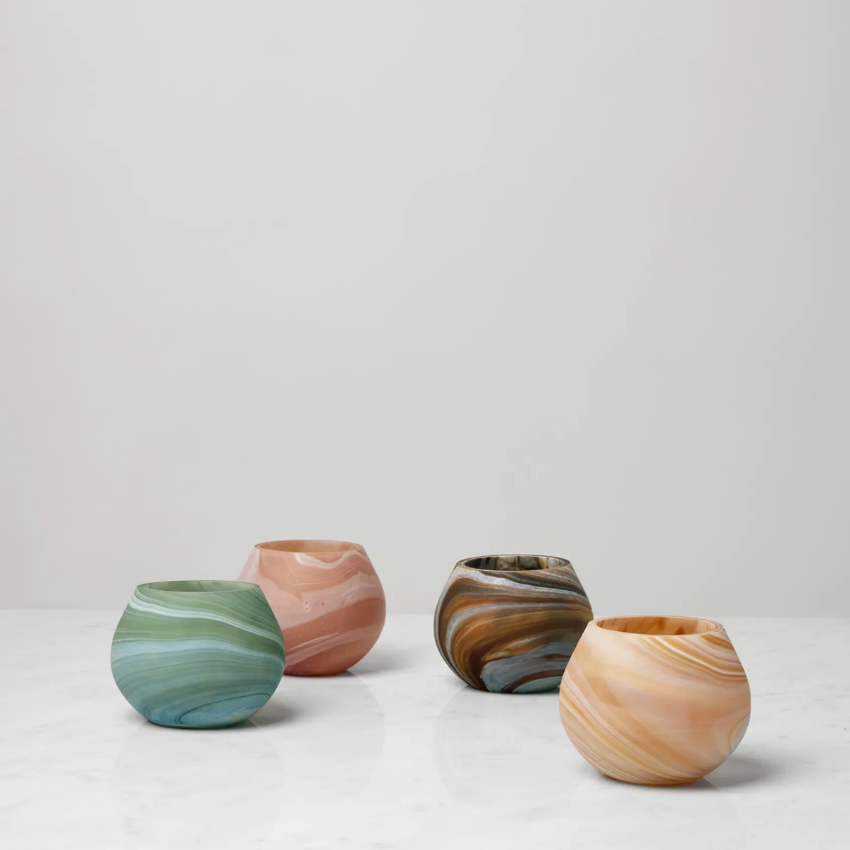 Four round, Sferra Giove Marbled Votive Holders offer unique home decor
