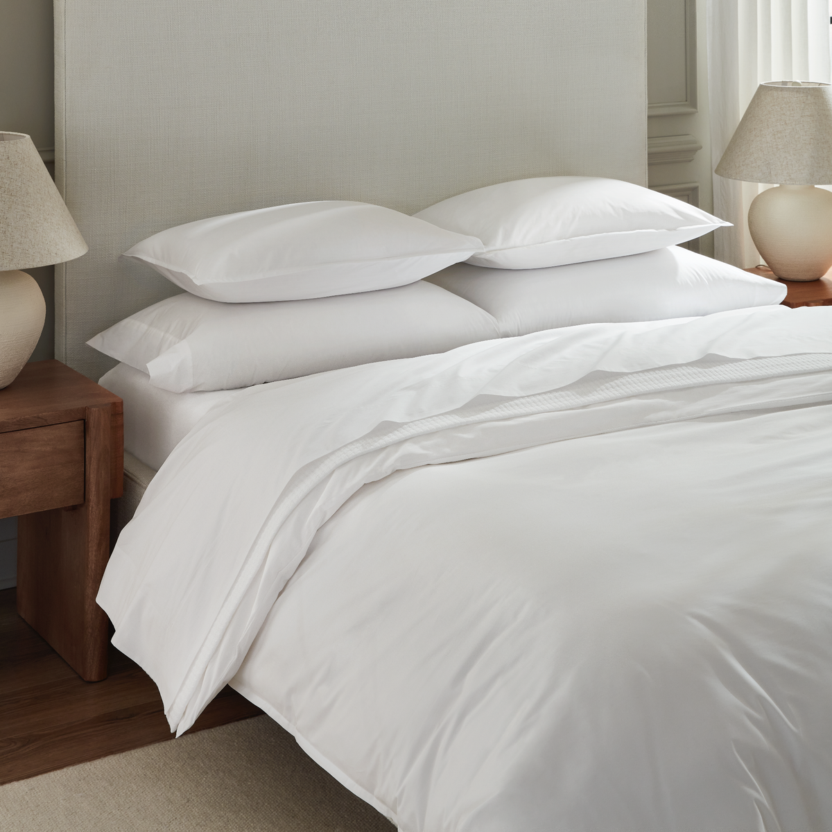 Angled View of Full Bed Dressed in White Sferra Giza 45 Corto Percale Collection