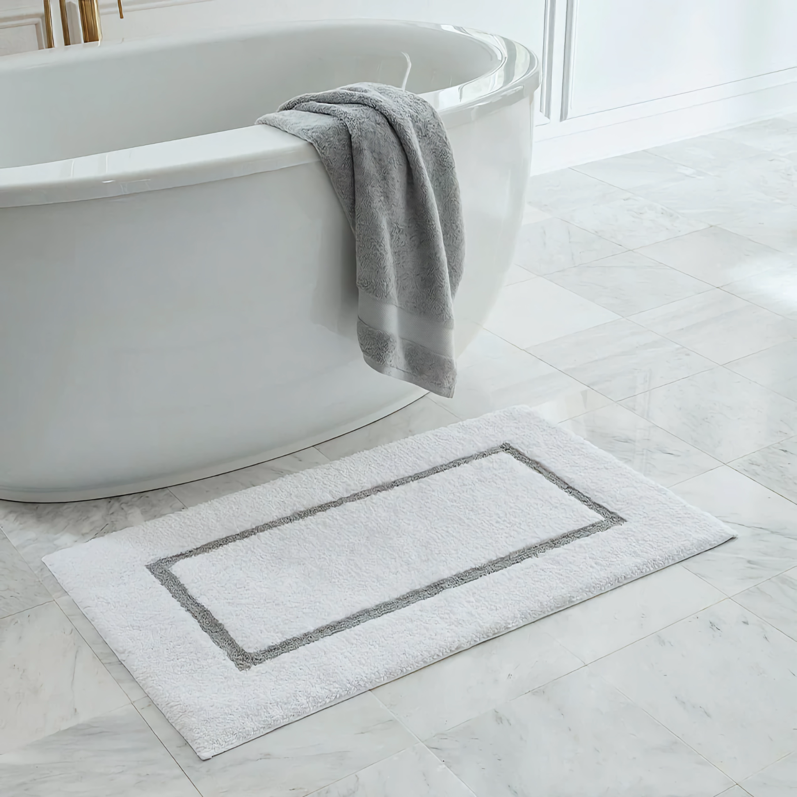 Sferra Lindo Bath Rug beside a Bath Tub