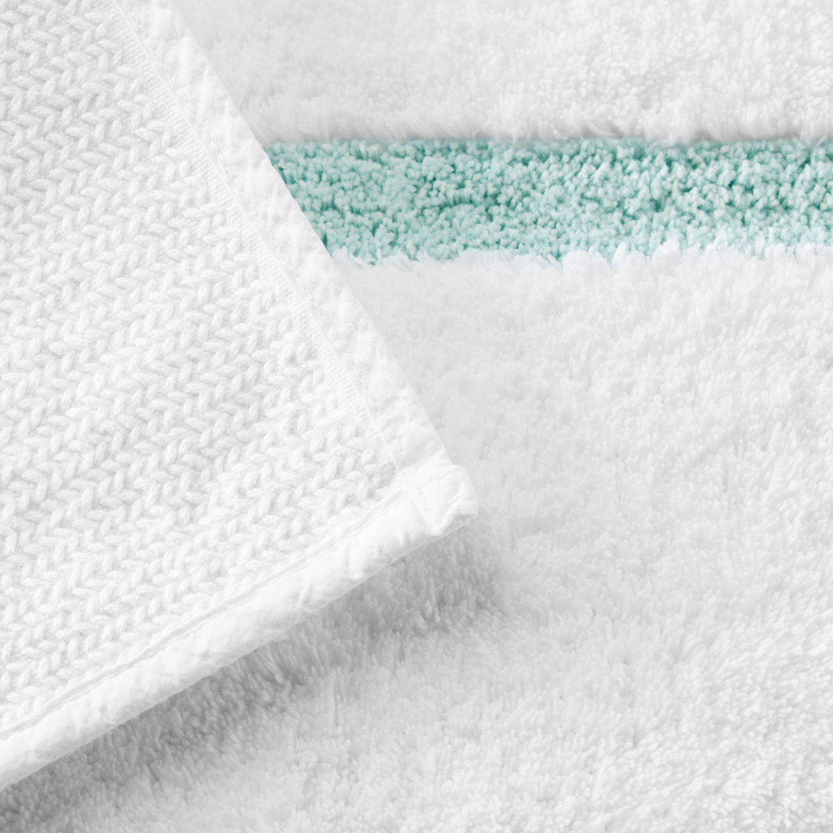 Underside View of Sferra Lindo Bath Rugs in White Aqua Color