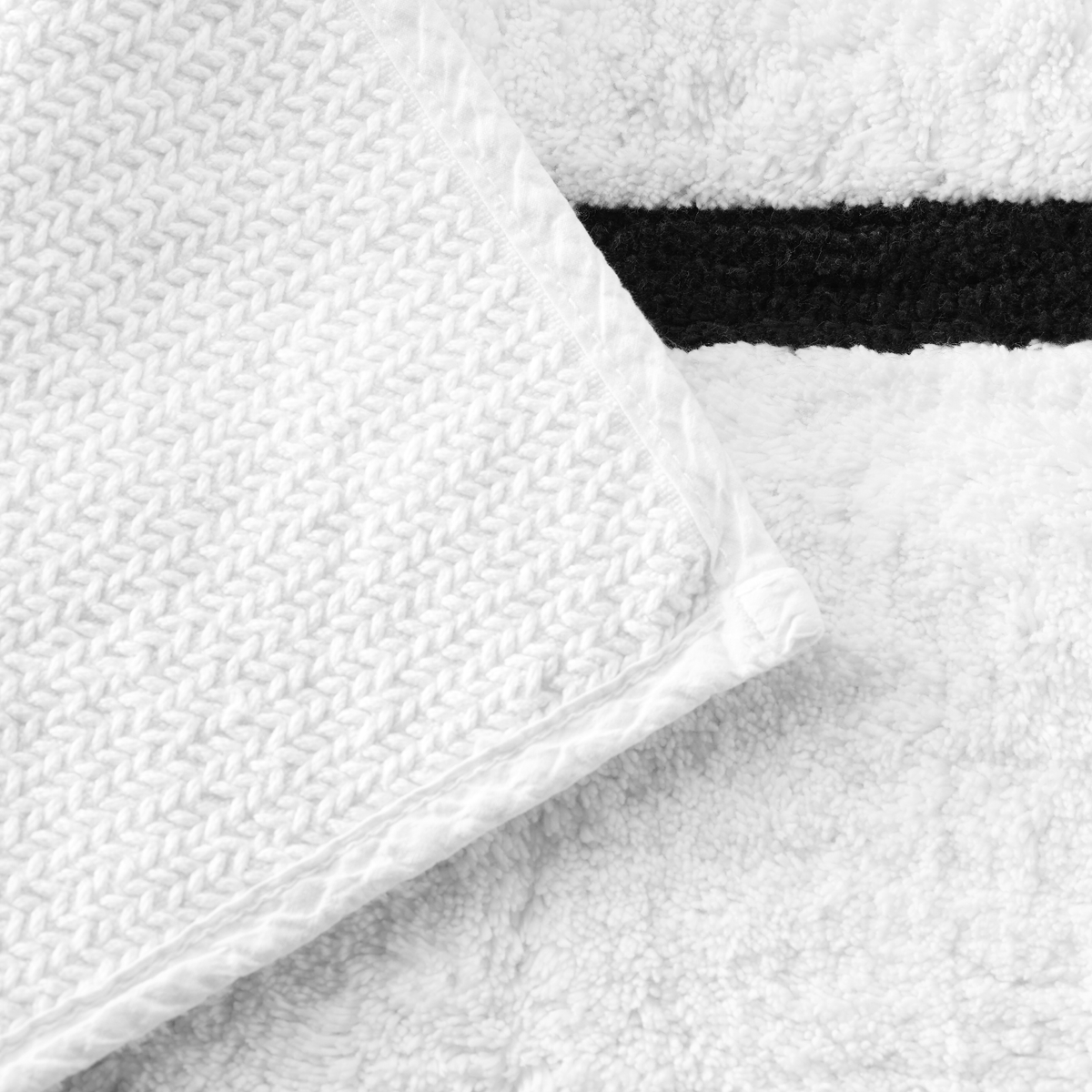 Underside View of Sferra Lindo Bath Rugs in White Black Color