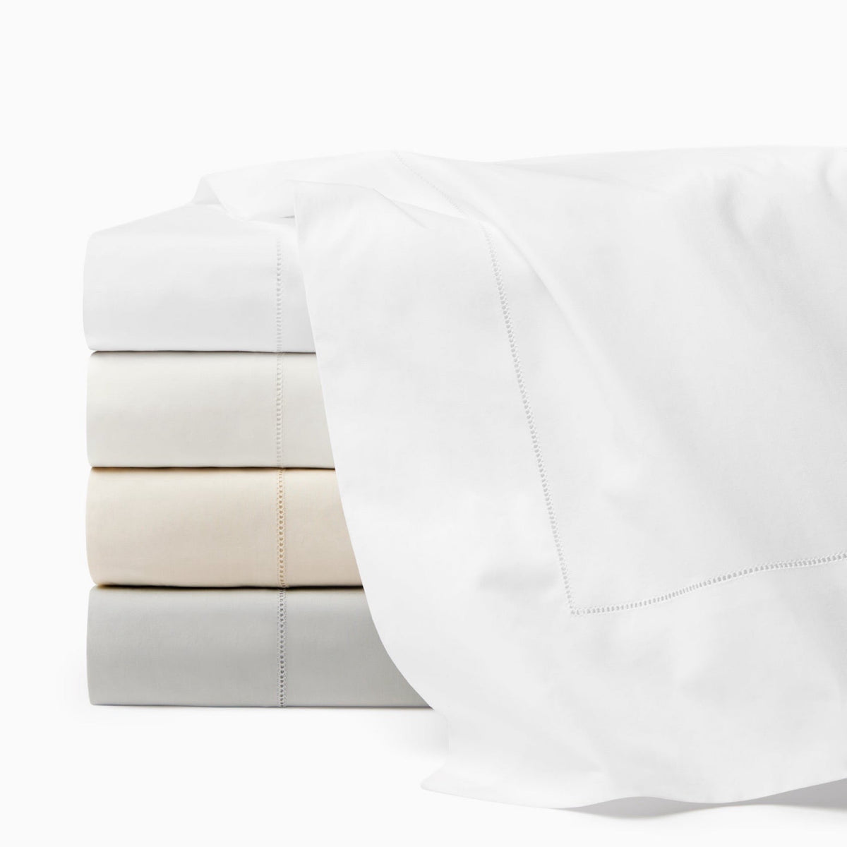 Stack of Sferra Luxor Flat Sheets in four colors