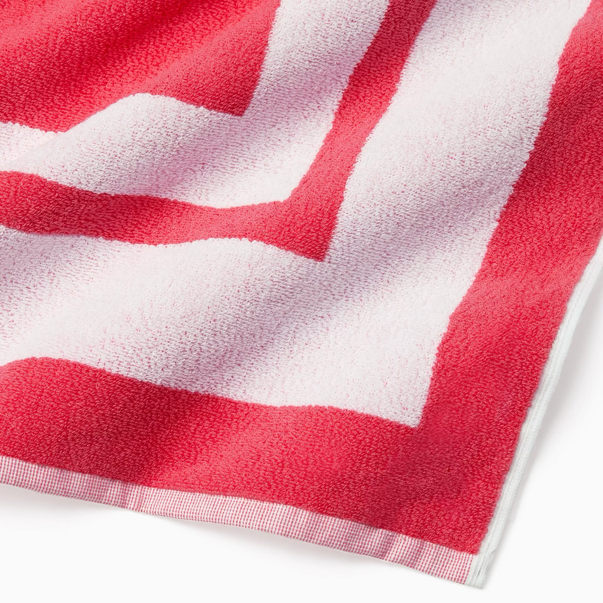 Corner Detail of Sferra Mareta Beach Towels in Coral color