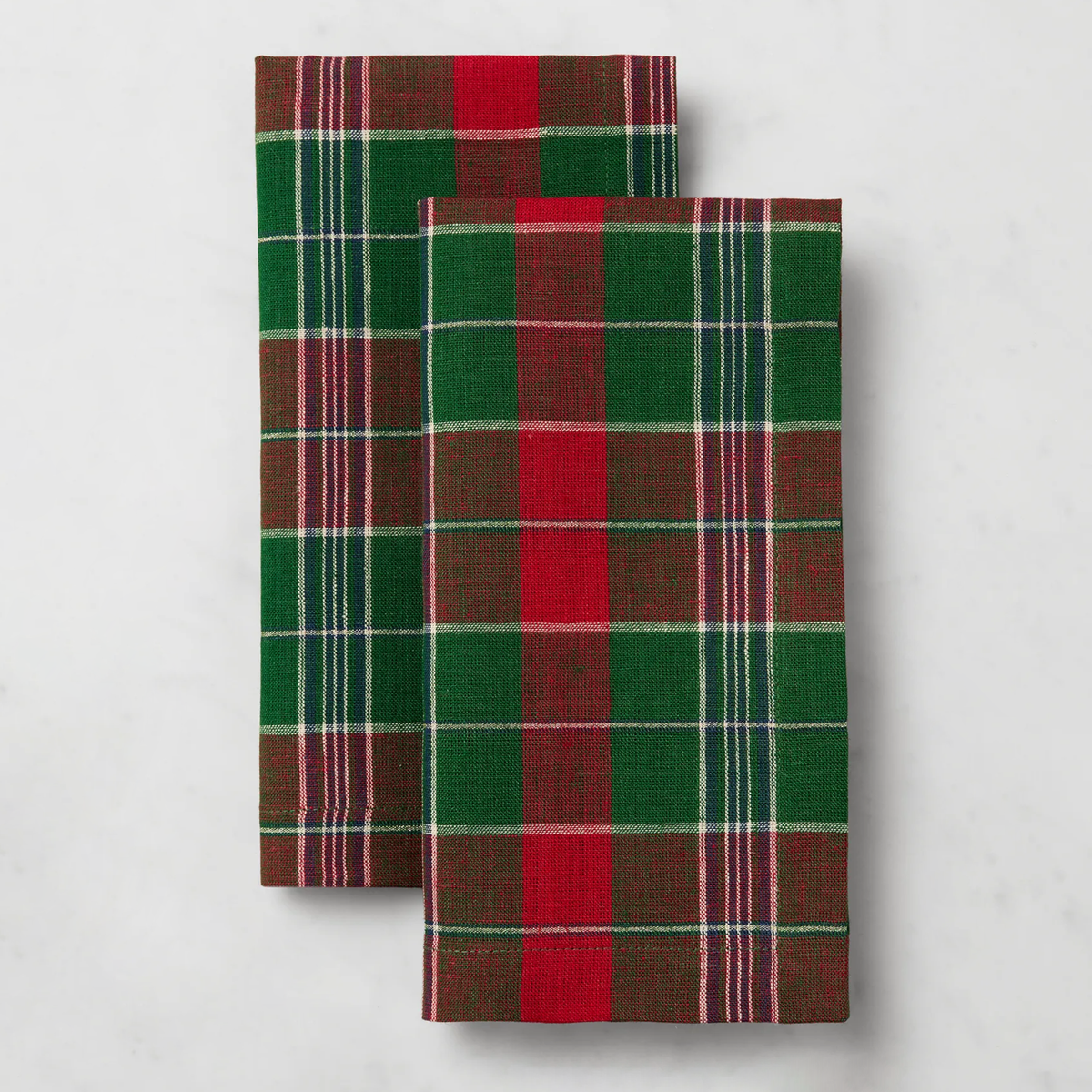 Two rectangular plaid Sferra Masseria Dinner Napkins in Emerald and Red colors