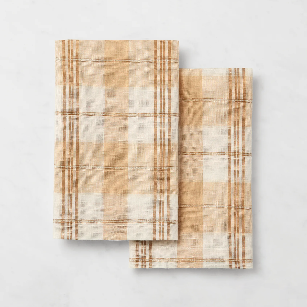 Two folded plaid Sferra Masseria Guest Towels in Almond and Oyster colors - add charm to your autumnal table decor.