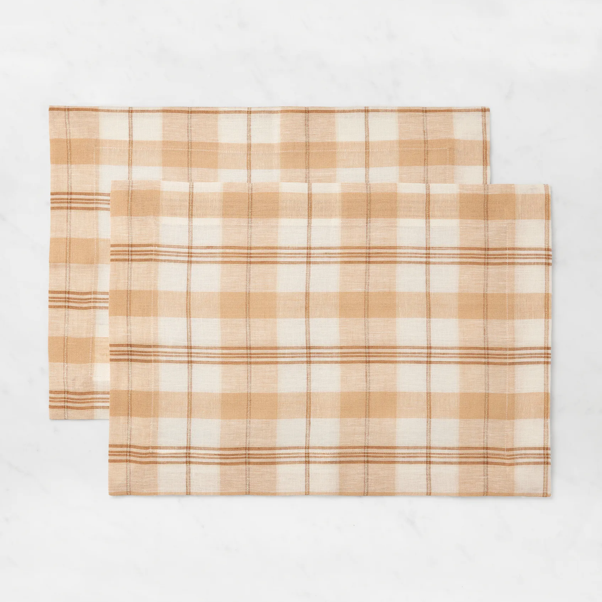 Two rectangular Sferra Masseria Placemats in Almond and Oyster colors—perfect autumnal table decor for your home.
