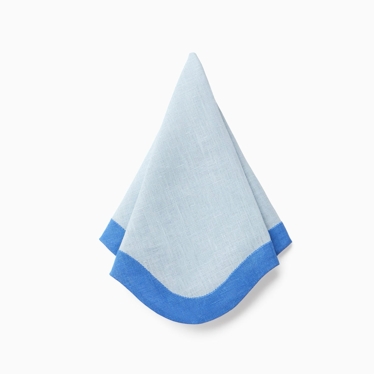 Hanging Sferra Dinner Napkin in Sky and Cobalt Against White Background