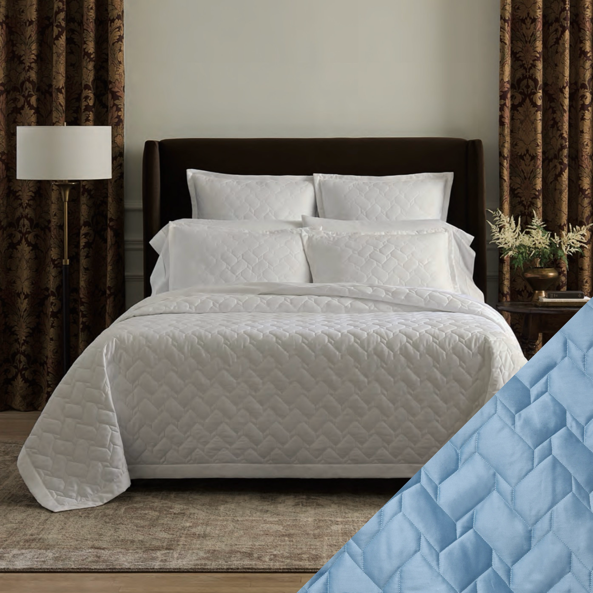 A neatly made bed with White Sferra Palatino Quilt and Shams, and a Sea quilt close-up in the corner.
