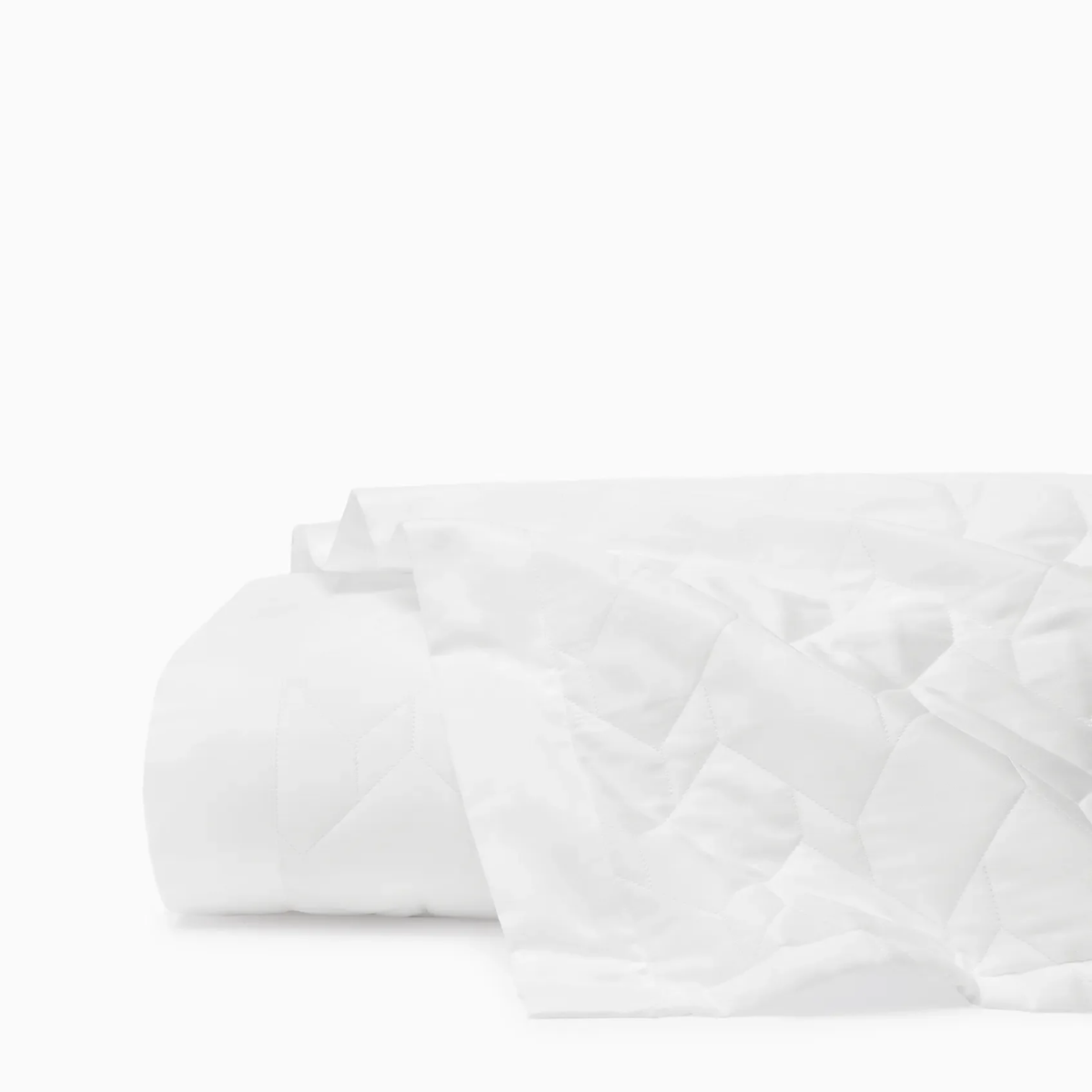 A folded Sferra Palatino Quilt in White color is shown against a plain white background
