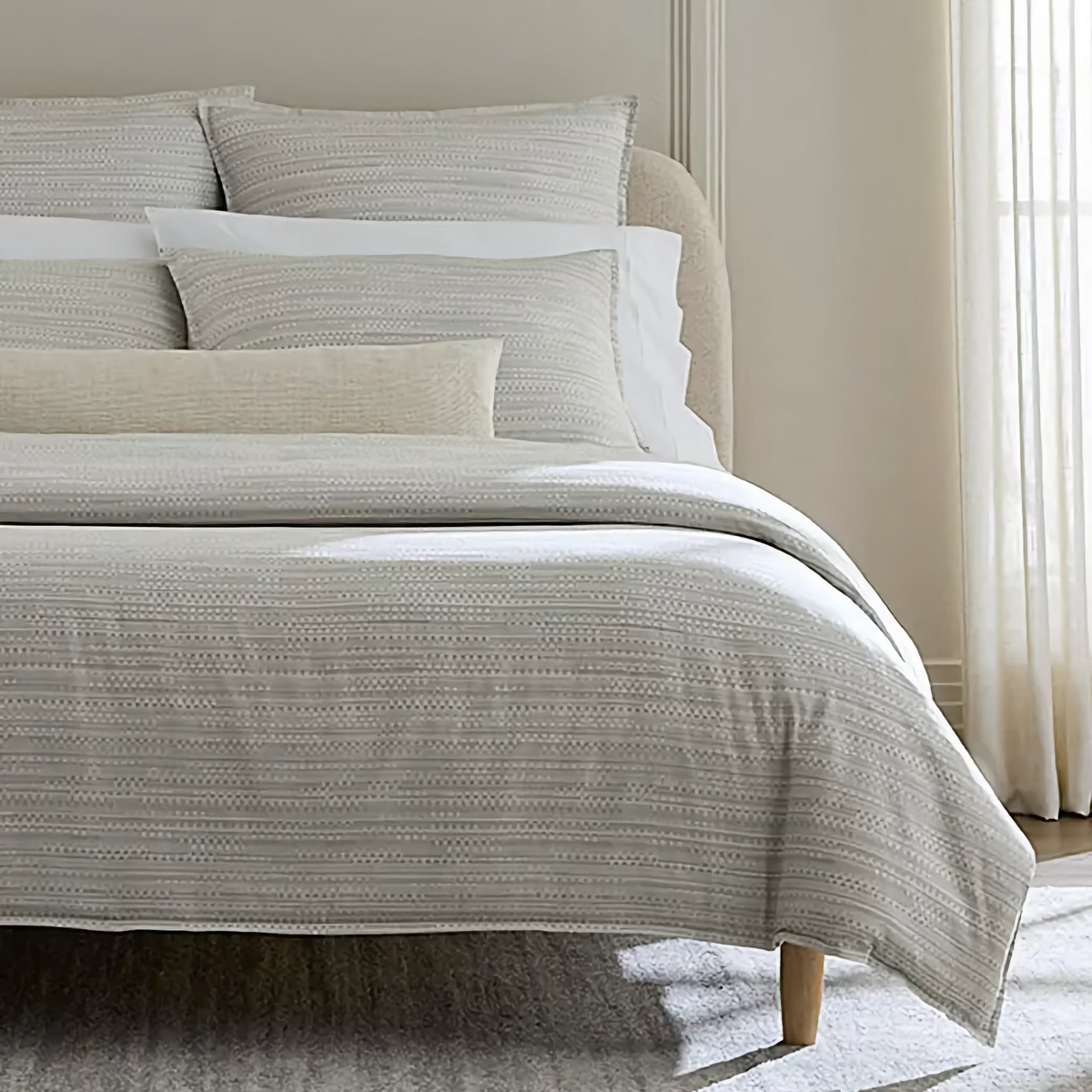 Closeup of Bed in Bone color Sferra Pellestrina Duvet Cover and Shams