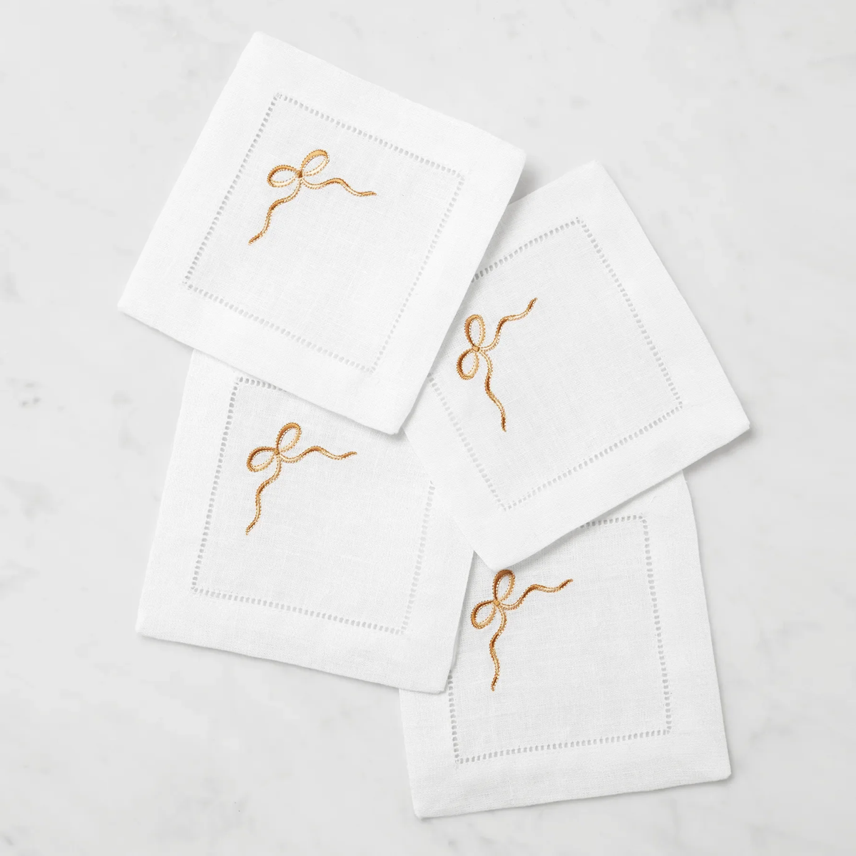Stack of Sferra Regalo Cocktail Napkins with White and Beige colors