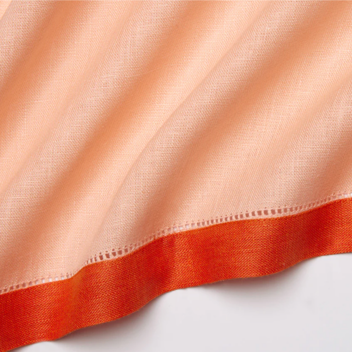Closeup of Sferra Roma Napkin Fabric in Cameo and Tangerine Color